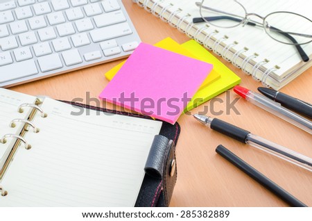 Notebook with pen and color note paper on Computer desk