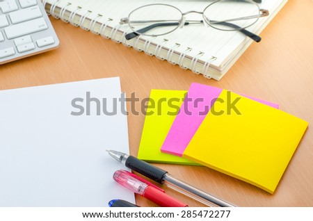 Blank paper with pen and color note paper on Computer desk