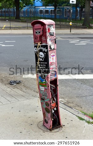 Brooklyn, New York - July 12, 2015: Graffiti covered fire callbox in  Williamsburg, Brooklyn. Williamsburg has become known as an arts and culture mecca in New York city.