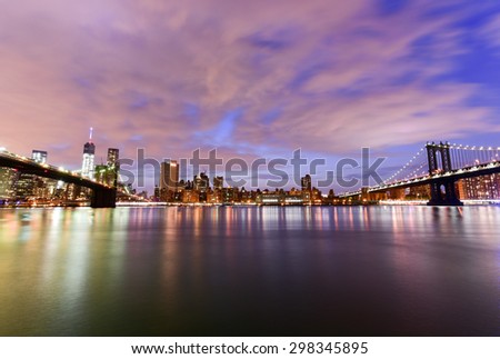 New York, New York - July 4, 2015: View of the Brooklyn Bridge and Manhattan Bridge at sunset from Brooklyn Bridge Park, New York.