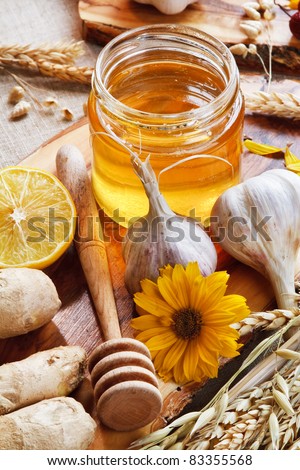 Honey and others natural medicine for the winter flue (garlic, lemon ginger). Rustic still life.