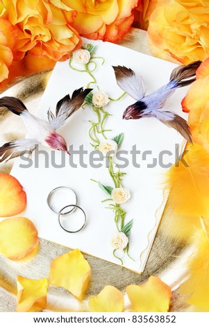 Wedding invitation, decorative still life with birds, roses, and feathers.
