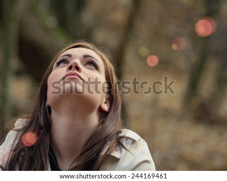 Beautiful young  woman in the forest / Look at the sky / Beautiful young  woman in the forest.