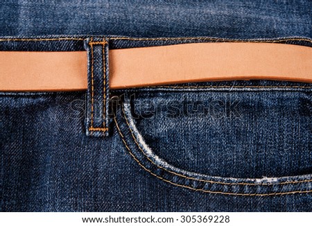 fashionable clothes. pile of jeans on a wooden background