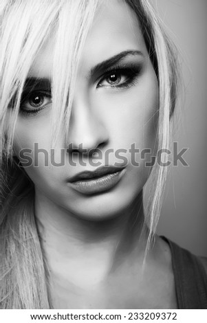 beautiful young woman with blond hair and perfect skin in black and white
