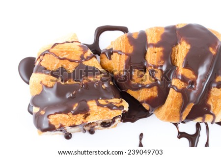 Two croissants with melted chocolate on them isolated on white
