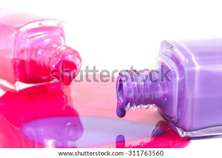 Pink and purple nail polish on the white background