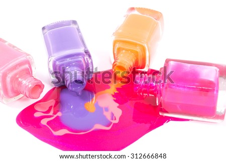Pink, orange and purple nail polishes on the white background