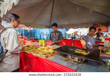 Kuala Lumpur,Malaysia - July 23, 2014 :The food seller preparing Murtabak fried for their customers during Ramadan bazaar in Kuala Lumpur