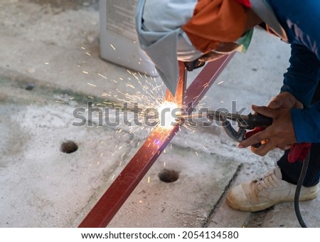 Similar – Image, Stock Photo Unrecognizable welder in hardhat with welding hose in garage