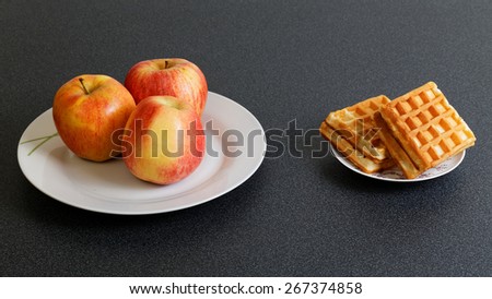 Apples and cookies on dark table. Make Your Choice.