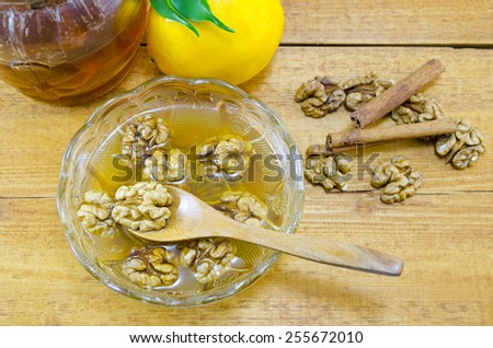 Walnuts honey  lemon and cinnamon in a jar on a wooden table