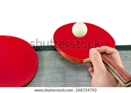 Male hand holding a ping pong racket and a table tennis ball above a net, isolated on white