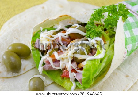 Tortilla sandwich with fresh vegetables and ham