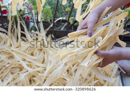 Homemade pasta in woman hands. Pasta production process
