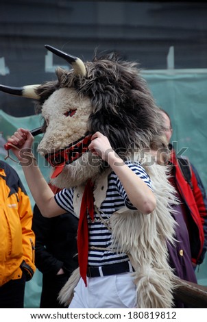 LJUBLJANA, SLOVENIA - MARCH 1, 2014: Zvoncar, traditional carnival mask from Croatia,  at Dragon Carnival in old town on Shrove Saturday. Masks banish away the winter and announce the spring.