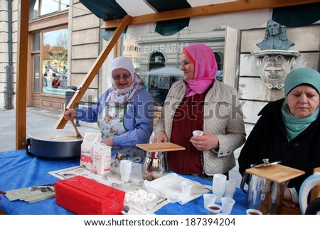 LJUBLJANA, SLOVENIA - APRIL 12, 2014: Women cook halva and offer free coffee at Festival of Bosnian Food and Presentation of Bosnian Rug organized by Women\'s Association Zemzem on Stritar street.