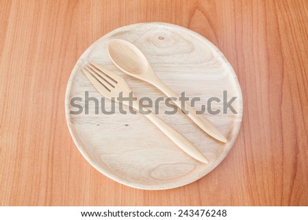 wooden plate and wood spoon on table wood texture background