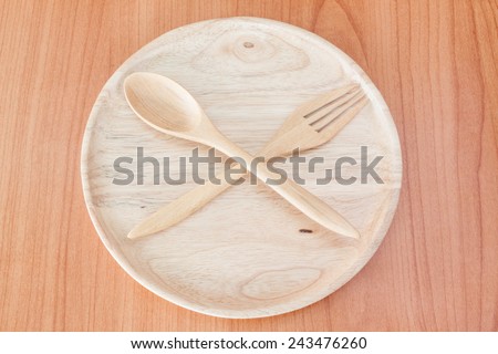 wooden plate and wood spoon on table wood texture background