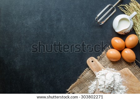 Baking powder milk and eggs on chalkboard for background