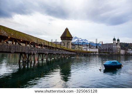 LUCERNE, SWITZERLAND - APRIL 16: Chapel Bridge, the wooden bridge with grand stone water tower on April 16,2015 in Luzern. The oldest wooden covered bridge in Europe.