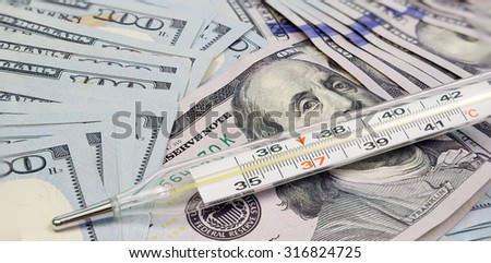 Health of money exchange market concept. Medical thermometer with money