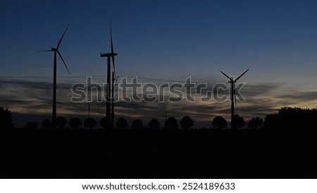 Similar – Image, Stock Photo Silhouettes of some wind mills on the top of a mountain during a super orange sunset with copy space peaceful