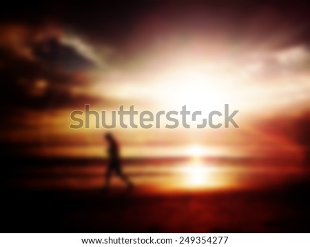Blur  background Silhouette of a man jogging on the beach in the morning