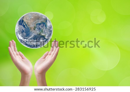 Hand holding earth on green background ,concept background , Elements of image are furnished by NASA