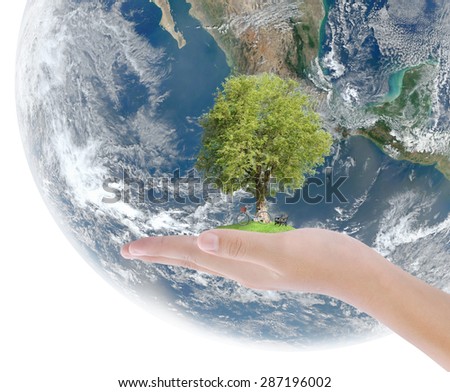 Hand holding tree,bicycle,chair on green grass and earth background , concept ,  Elements of image are furnished by NASA
