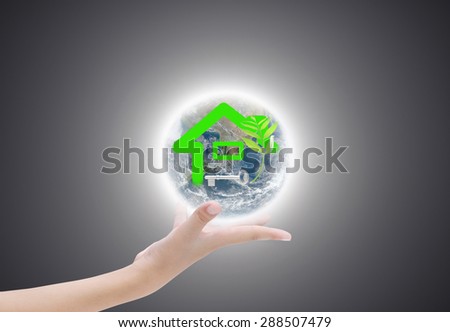 Hand holding house on earth , Elements of image are furnished by NASA