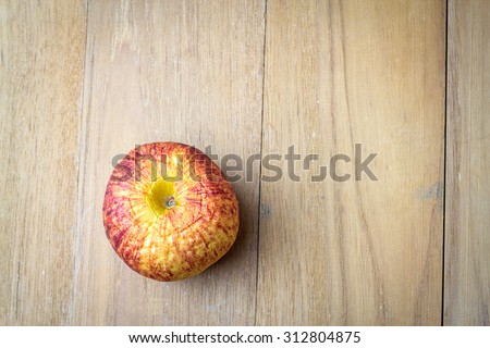 old apple on wooden board