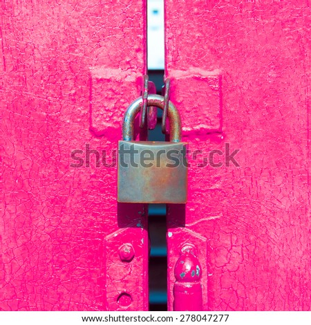 Padlocked on pink door.