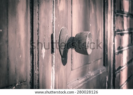 Rustic door knob and keyhole on the old wooden door, Vintage style.