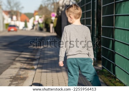 Similar – Foto Bild Kleiner blonder Junge in Winter-Oberbekleidung im Freien