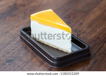 Similar – Image, Stock Photo Cheesecake slice with lemon syrup topping. Slice of cheesecake close-up