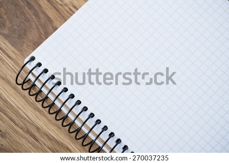Blank spiral notebook on an oak wood table