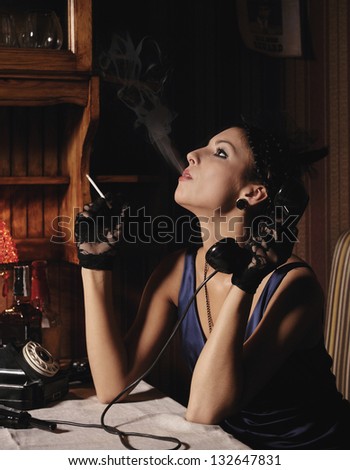 Woman portrait  in retro style, smoking and talking by phone.