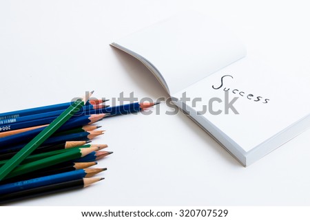 Success concept write down in a white paper book with pencil and  used eraser on white paper book