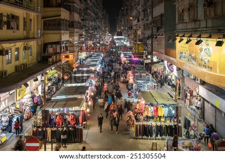 Hong Kong, - February 6, 2015: People crowded in the local market, downstairs the old buildings in Mong Kok, Hong Kong.