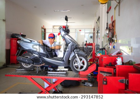 Hochiminh City, Vietnam - June 23, 2015: Professional motorcycle repairman at a service center of Honda motorcycles in Ho Chi Minh City, Vietnam