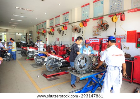 Hochiminh City, Vietnam - June 23, 2015: Professional motorcycle repairman at a service center of Honda motorcycles in Ho Chi Minh City, Vietnam