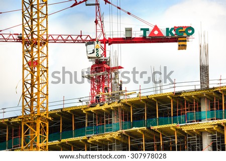 Hochiminh City, Vietnam - August 11, 2015: Big yellow construction crane is used in ares in HoChiMinh city RESIDENTAL bulting