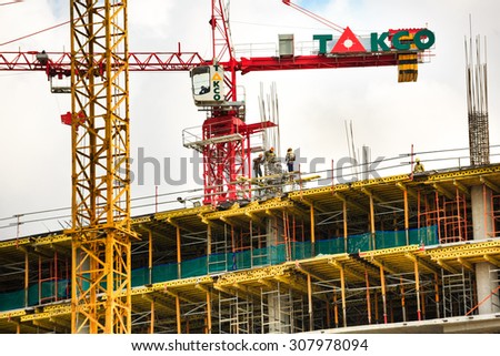 Hochiminh City, Vietnam - August 11, 2015: Big yellow construction crane is used in ares in HoChiMinh city RESIDENTAL bulting