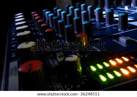 Mixing console at night. Musical background.