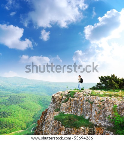Girl on the peak of mountain. Landscape composition.
