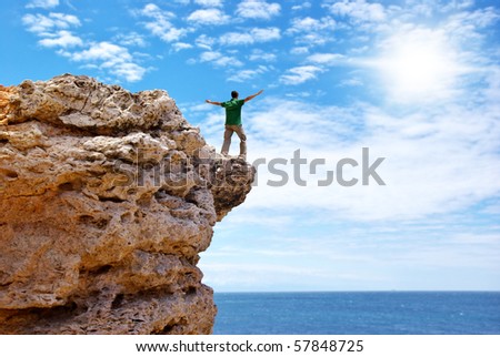 Man on the edge of cliff. Emotional scene.