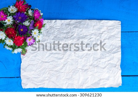 Bunch of flowers and sheet of paper