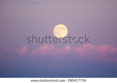 Moon in last rays of light after sunny day