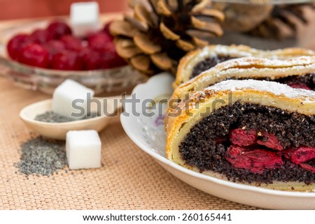 Poppy seed strudel with cherry on the sacking